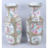 A pair of Canton enamel famille vert rouleau vases with figured panels, 17 1/2" high (one drilled as