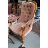 A Victorian walnut showframe spoon back chair, button upholstered in a pink velour, on turned