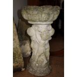 A cast stone birdbath, on scroll base