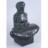 A Scandinavian seated figure, with runic inscription, 10" high (chips)