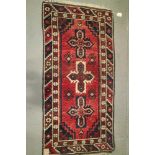 A Hamadan type rug with three star guls on a plum ground, 54" x 27" approx