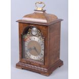 An early 20th century walnut cased bracket clock with brass carrying handle, gilt decoration,