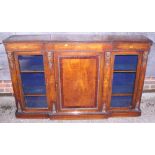 A late Victorian figured walnut, inlaid and gilt brass mounted breakfront credenza enclosed two