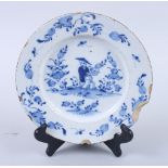 A Lambeth delft blue and white plate, decorated with Oriental gentleman and flowers