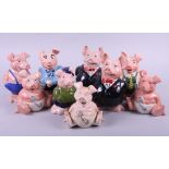 A set of six "NatWest Piggy banks" and two babies and father