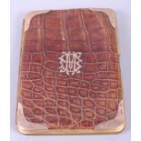 A Victorian crocodile skin card case with 9ct gold corners and initials