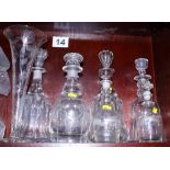 A 19th century bell-shaped decanter with stopper, six other 19th century decanters, stoppers and