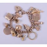 A 9ct rose gold charm bracelet with heart-shaped clasp, mounted a 1915 half sovereign, a 22ct gold