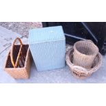 A Lloyd Loom linen basket together with a cane magazine rack and two baskets