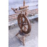 A vintage oak spinning wheel