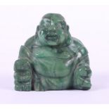 A Chinese carved jade seated Buddha, 1 7/8" high