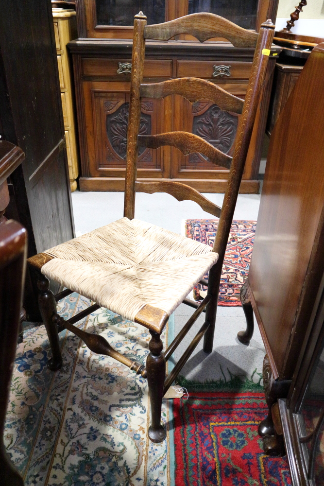 Two 19th century oak and ash ladder back chairs with rush envelope seats, on turned and