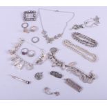 Two silver bracelets, mounted various charms, a silver ingot, a silver rope twist chain, a silver