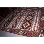 A Moroccan mixed flat weave and pile panelled rug with hooked medallions and Kazak style guls,