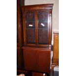 A Victorian walnut book case with glazed upper section over cupboards enclosed arch top panel doors,