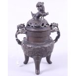 A Chinese bronze two-handled censer, decorated dragons and flowers and mounted Dog of Fo to lid,