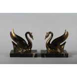 A pair of Art Deco anodised Swan and Emperador marble book ends, 5 1/2" high