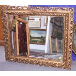 A bevelled edge wall mirror, in gilt frame, plate 15" x 19", and a smaller pine framed mirror