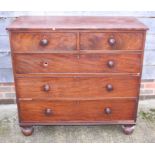 A Victorian mahogany chest of two short and three long drawers with knob handles, on bun supports,