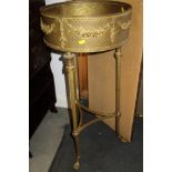 An early 20th century brass jardiniere with swag decoration, on tripod splay supports