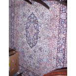 A hand-knotted Kashmir silk rug with central medallion, floral decoration and multi-borders, 84" x