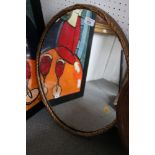 An oval gilt framed wall mirror, plate 20" x 16 1/2"