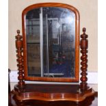 A Victorian figured walnut arch top swing frame toilet mirror, on barley twist supports and