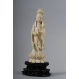 An early 20th century Chinese carved ivory figure of Kuan Yin standing on a lotus flower, 5 3/4"