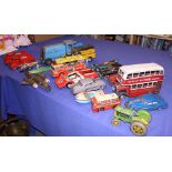 A collection of tin-plate toys, including cars, a fire engine, boats, busses, etc