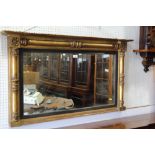 A rectangular overmantel mirror, in gilt and ebonised frame, 42" wide