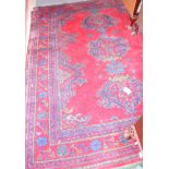 A Turkey rug of traditional design on a red ground and floral border, 88" x 70" approx