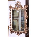 A gilt framed wall mirror of Georgian design and a white painted framed oval wall mirror