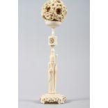 A Chinese carved ivory nesting ball with dragon design, on ivory stand formed as Lao Tzu, ball 2 1/