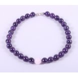 A cherry amber coloured graduated bead necklace and an amethyst and rose quartz bead necklace