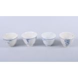 Four 19th century and later blue and white tea bowls, mostly decorated with foliage