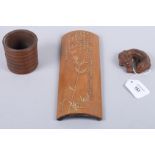 A Chinese carved bamboo dragon, 3" wide, a wrist rest, 10" long, and a brush pot, 2 3/4" high