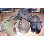 A mid 20th century Brodie tin helmet, a similar French helmet, a pair of leather boots, two canvas