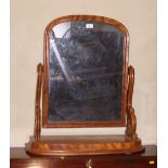 A late 19th century mahogany swing frame toilet mirror, on bowfront plateau base, 26" wide