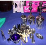 A pair of silver plate candlesticks, a three-piece teaset, and other plate, including salt and