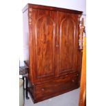 A 19th century wardrobe enclosed arch top doors over one long drawer, on block base, 51" wide x