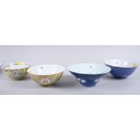 Two Chinese porcelain bowls with yellow grounds and two Chinese porcelain bowls with blue grounds