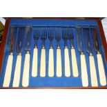 A set of twelve dessert knives and forks, in mahogany canteen, a pair of silver plated fish