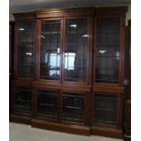 A 19th century Irish Adam design mahogany breakfront bookcase, the upper section with dentil cornice