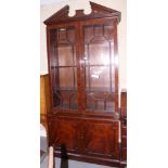 A George III design mahogany bookcase, the upper section with broken pediment over astragal