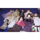 Two bisque headed dolls, one in a fairy costume, and a collection of bisque and fabric dolls