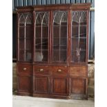 A chemist's Georgian mahogany shallow breakfront library bookcase, the upper section enclosed four