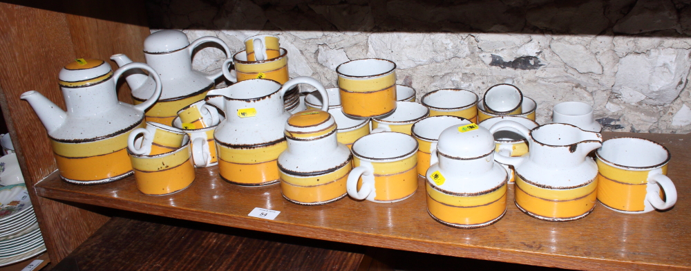 A Midwinter Stonehenge "Sun" pattern tea service, including two teapots, a milk jug, sugar (