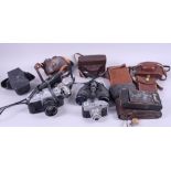 A pair of Hilkinson Lincoln 10x40 binoculars, a Kodak folding camera, and a collection of other