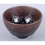 An Oriental brown glazed pottery tea bowl, 3 1/4" dia