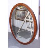 An Edwardian walnut and line inlaid oval framed wall mirror, 32" max dia